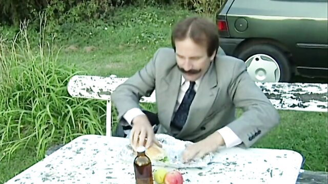 Karen Lancaume in suit eating sandwich at picnic in The Movie Star