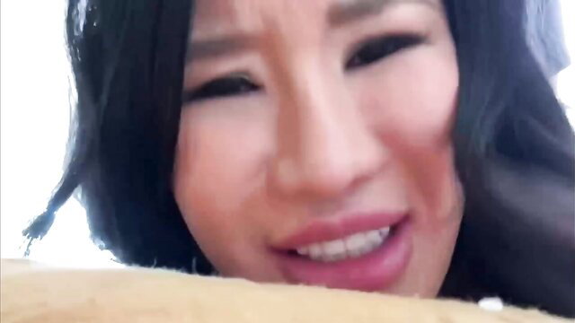 Asian Lily closeup face squinting with parted lips in Year Of The Dragon