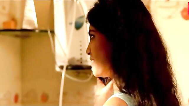 Indian beauty with long black hair in tight top, seductive profile view