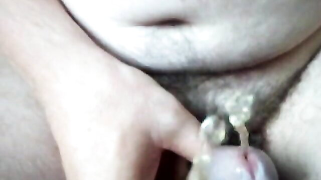 Closeup amateur hand spreading hairy pussy lips with golden piss dripping