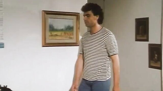 Curly-haired man in striped shirt and jeans in softcore erotica scene