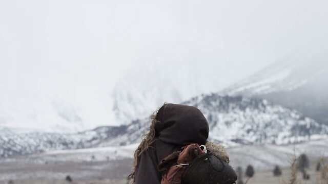 Elena Koshka in hooded jacket at snowy mountain camp