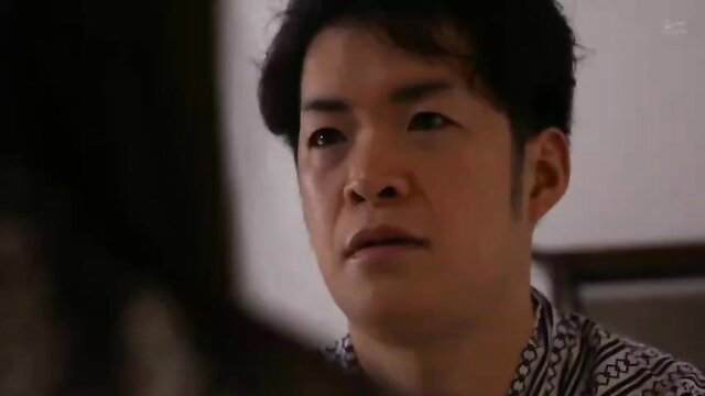 Asian man in batik shirt stares intently in JAV wife stealing scene