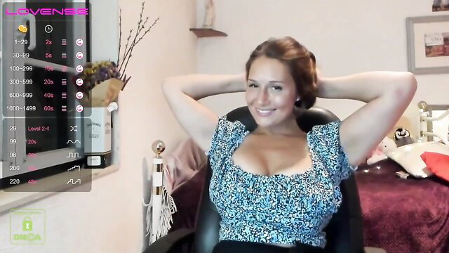 Busty brunette MILF in cleavage-baring dress smiles seductively