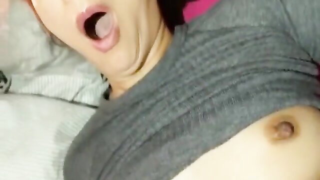 Closeup of busty Asian woman with hairy bush opening mouth wide on bed