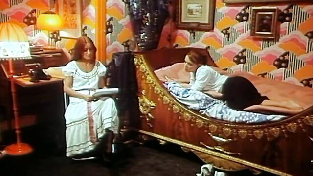 Two redhead women in white dresses on bed in Innocence pervertie