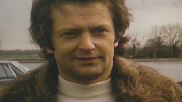 Vintage 70s French erotica man in fur coat by riverbank