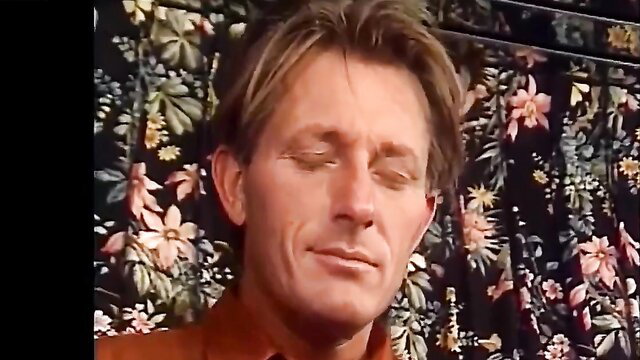 Mature man with long blonde hair in serene closeup portrait