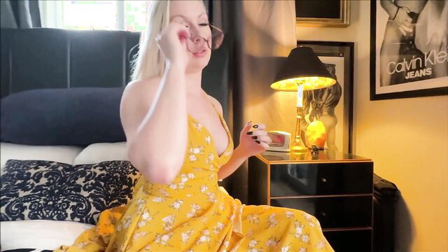 Sydney Paige blonde stepmom in yellow floral dress on bed