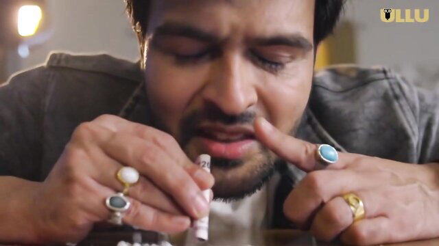 Indian bearded man with rings smoking joint in Ullu Palang Tod
