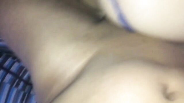 Blurry closeup of pale woman's cleavage and midriff in sheer top, BangBros style