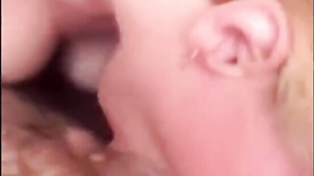 Closeup of woman deepthroating cock with cum overflowing from mouth