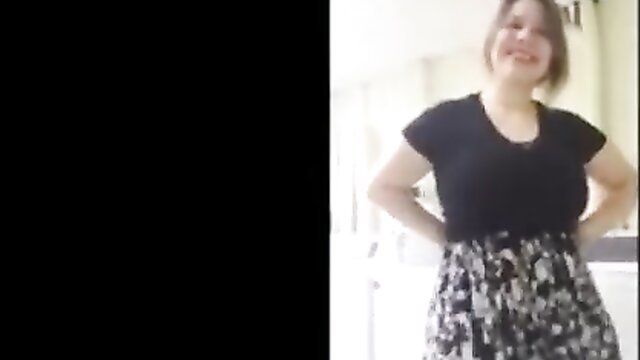 Mal Malloy smiling in tight black top and skirt, huge natural tits