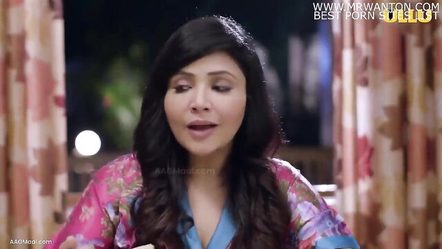 Indian stepmom in floral robe smiles seductively, adult video thumbnail