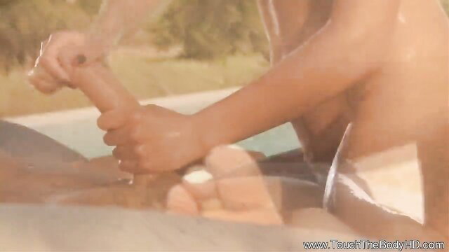 Asian massage therapist strokes cock outdoors by pool