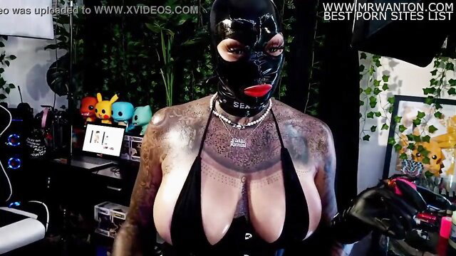 Nellie Hentai in latex mask and bikini tattoos herself