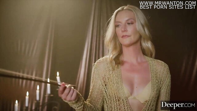 Mona Azar in sheer lingerie holds candle in Deeper reverse gangbang