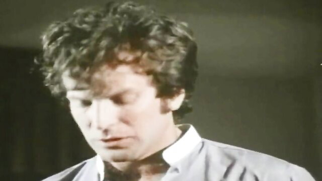 Vintage 80s man with curly hair in closeup portrait, classic adult film thumbnail