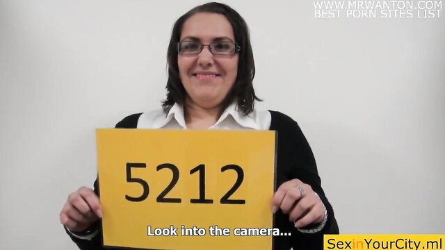 Big-breasted big-ass Michaela holds number 5212 at casting, smiling at camera