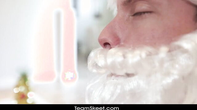 Closeup of seductive Santa Claus man with white beard, eyes closed in pleasure