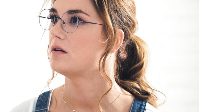 Siri Dahl closeup in glasses and ponytail, sexy lingerie tease