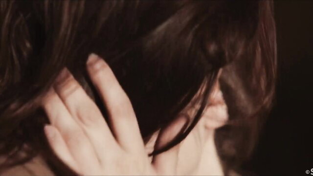 Emylia Argan closeup hand in brunette hair seductive tease