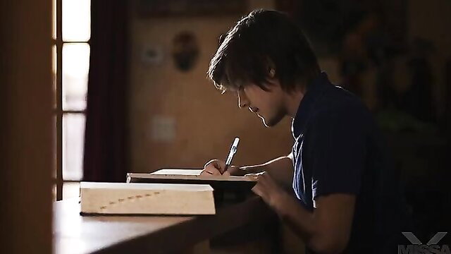 Young stud writing in notebook during study session with RayVeness