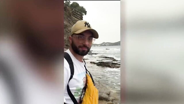 Bearded man in cap poses at beach cliff, French MILF Mikess hardcore