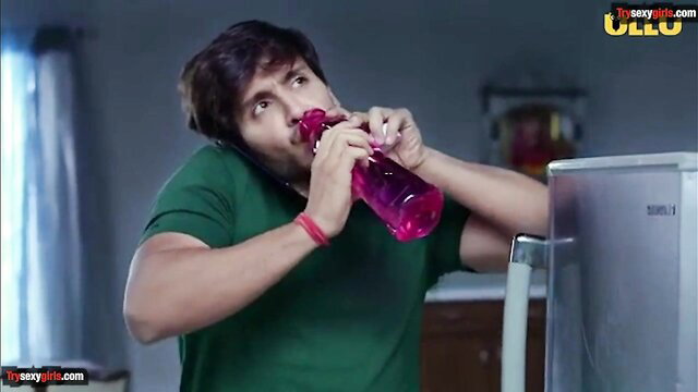 Indian man drinking from pink bottle in green t-shirt, Ullu adult video thumbnail