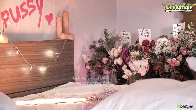 Cute amateur teen in pink bedroom with PUSSY sign, dildos and flowers