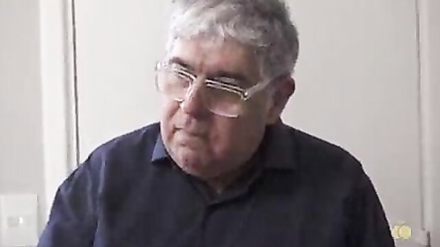 Mature gray-haired man in glasses, dark shirt, from Blazer Rager KeilaBassi7 tattoo vid