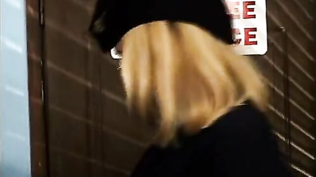Katie Morgan in beanie and glasses at police entrance, Specs Appeal