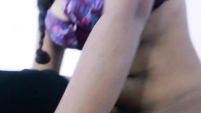 Indian wife in purple sports bra, toned abs and braid visible in hot pose