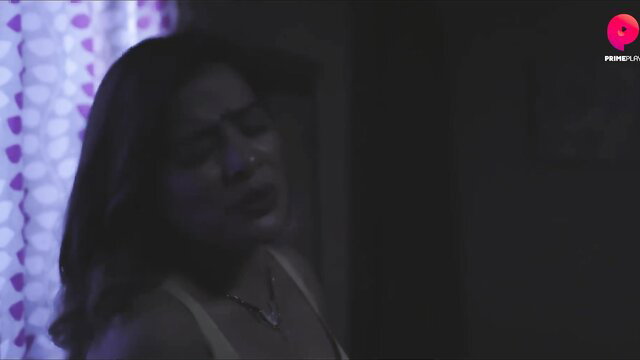 Indian MILF in dim-lit room with purple curtains, seductive gaze