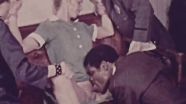 Retro porn: blonde in green dress cunnilingus by suited man in warden's office