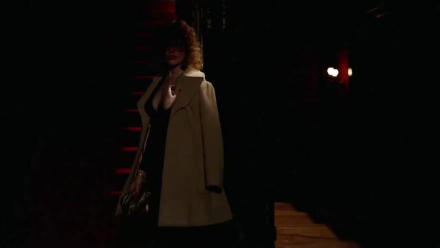 Vintage 1982 brunette in trench coat and dress on stairs, sexy tease