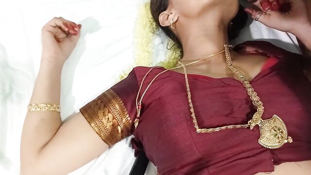 Tamil housewife in red saree with gold jewelry lying seductively