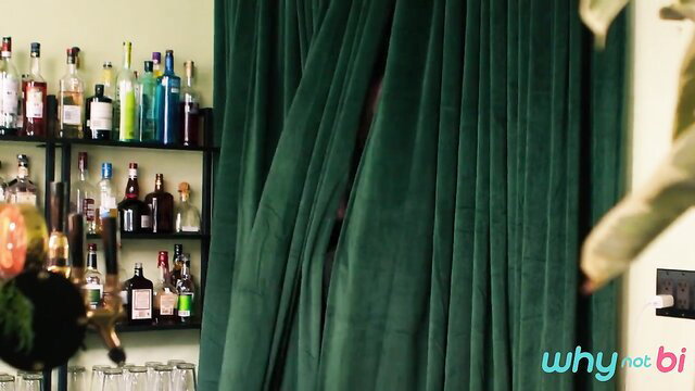Bar shelves and green curtains in Valentine's Day bi threesome setup