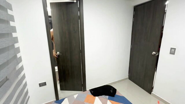 Sara Brown in bedroom with open doors, black rug on floor