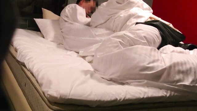 Asian babe wrapped in white sheets on bed in FC2 amateur video