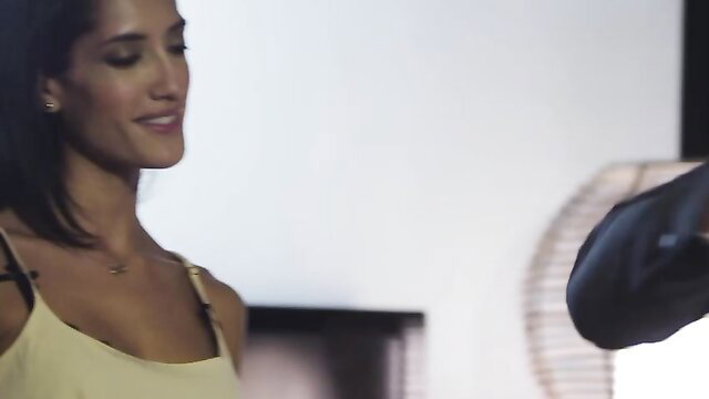 Chloe Amour in yellow tank top smiles seductively close-up