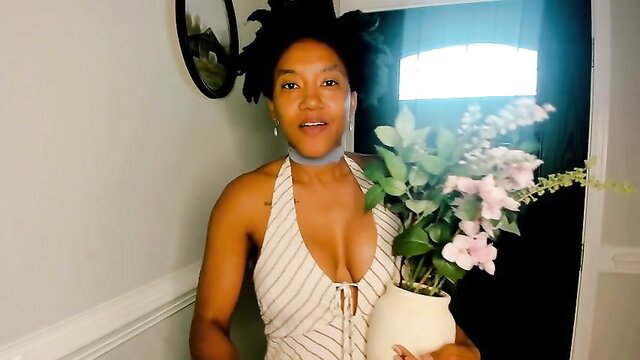 Rosaline Capulet in sexy striped sundress holding flowers at door