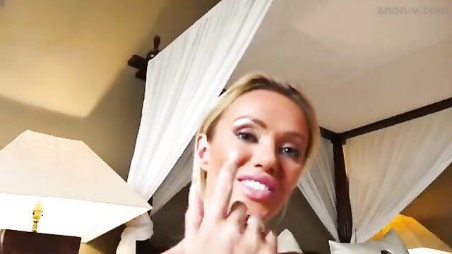 Blonde Lucy Zara smiling seductively in hotel bed, lips pursed