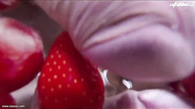 Closeup of big cock between juicy red strawberries, erotic food play tease