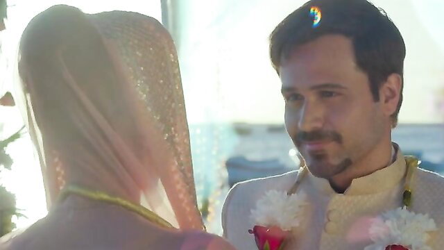 Indian bride in gold saree and groom in sherwani at romantic sunset wedding