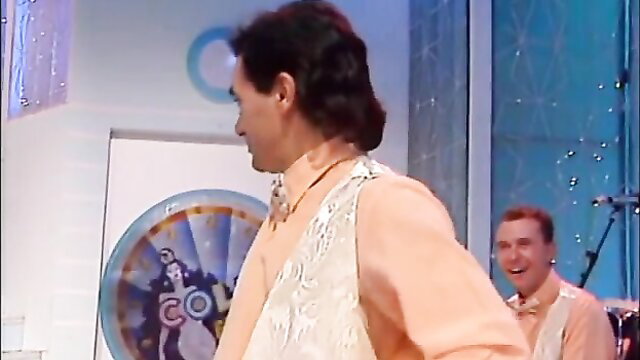 Colpo Grosso DLXXIII men in shiny vests on game show set