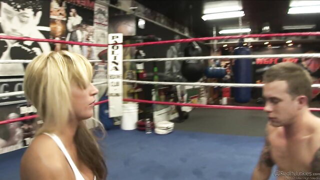 Scott Stone topless facing stunning blonde beauty in gym