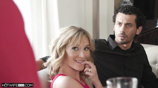Mona and Alex in a sensual scene with Mona smiling and Alex looking serious