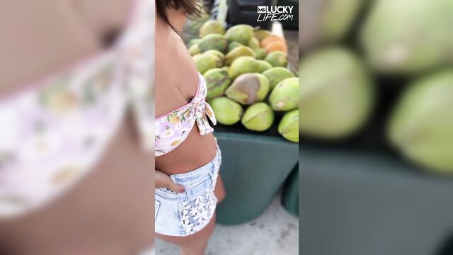 Malina Melendez in floral bikini and daisy duke shorts at market