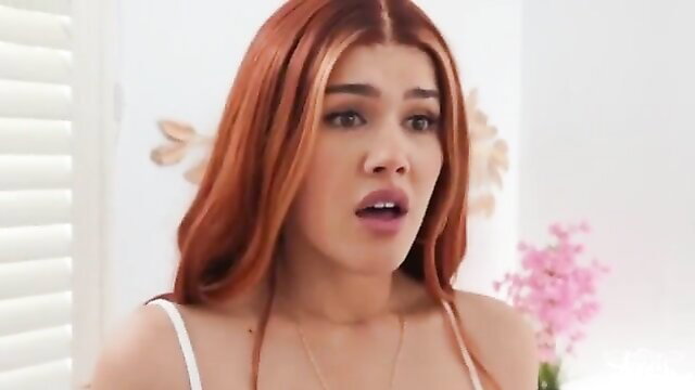 Redhead model shocked expression in white lingerie closeup
